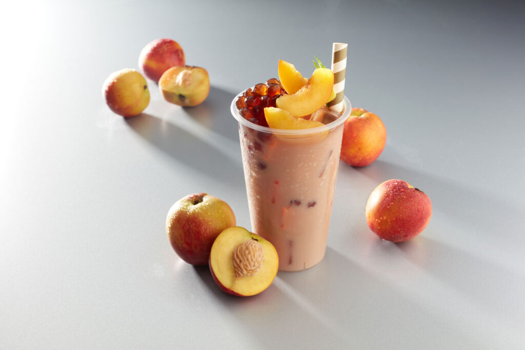A refreshing smoothie with a variety of fresh fruits and a straw for sipping