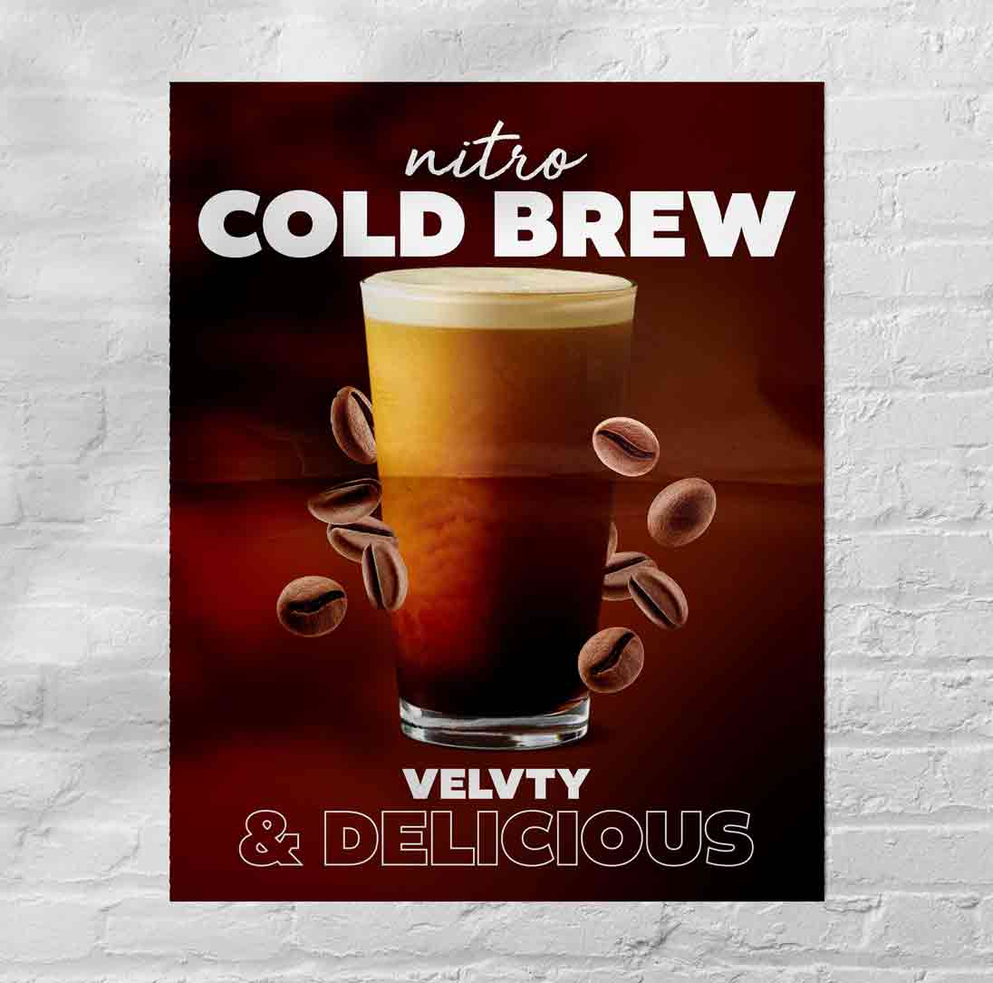 A poster on a brick wall advertising a cold beverage
