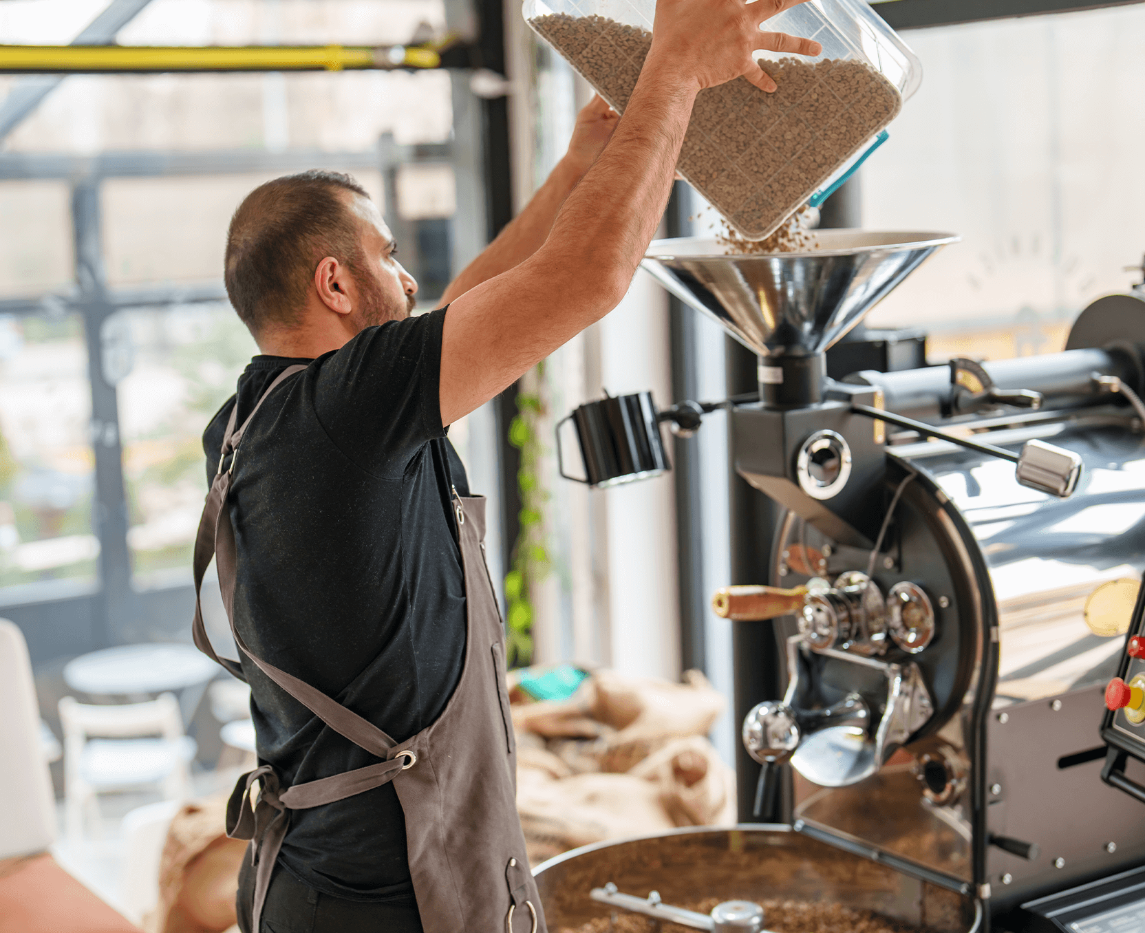 a man pouring coffee into a coffee machine