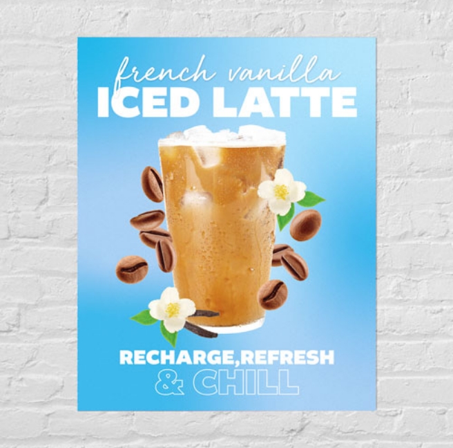 A poster featuring an iced latte displayed on a white brick wall